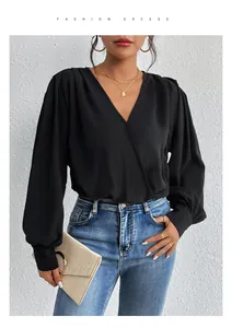 Detail of elegant black V-neck wrap bodysuit with pleated shoulders and cuffed sleeves