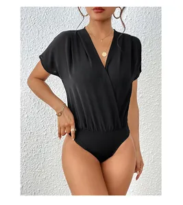 Detailed view of the elegant deep V-neckline and gathered waist of the black bodysuit