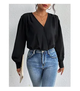 Detail of elegant black long sleeve wrap jumpsuit with V-neckline and lantern sleeve cuffs