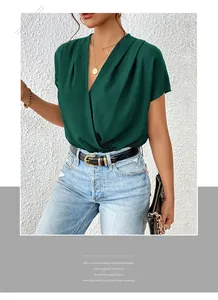 Detail of dark green V-neck wrap top with short batwing sleeves and premium draped fabric