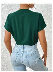 Back view of a deep green short sleeve bodysuit paired with light blue high waist jeans