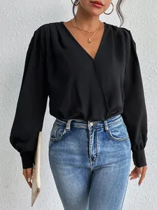 Elegant black V-neck long sleeve bodysuit with wrap design and blue denim jeans