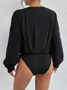 Elegant black long sleeve bodysuit featuring pleated back detail and ribbed knit bottom