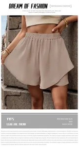 Detail of high-waist layered shorts with textured fabric and elastic waistband