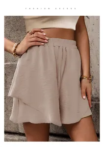 Detail view of high waist shorts with textured pleats and elastic waistband