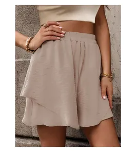 Detail showing the elastic high waist and textured layered fabric of casual shorts