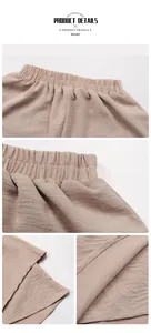 Close-up of high-waist elastic band and crinkle texture on beige casual shorts