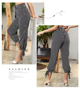 Detail showing high-waisted black and white striped pants with drawstring hem knots