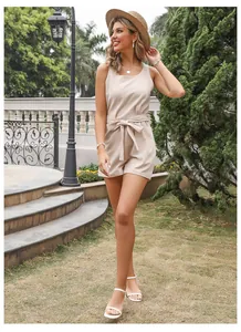 Detail view of beige cotton linen romper featuring a round neck and waist tie ribbon design
