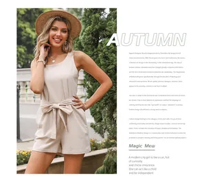Detail of loose beige linen romper featuring a tie-waist and sleeveless summer design