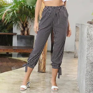 Women's high waist black and white striped trousers with bow tie cuffs and elastic waistband