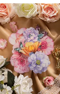 Macro detail of large floral PET stickers with vibrant butterflies on gold velvet backdrop