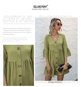 Detail of sage green babydoll dress with decorative buttons and ruffle trim texture