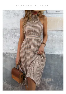 Detail of checkered halter neck dress featuring high waist and pleated long skirt texture