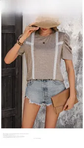 Detail of brown t-shirt with vertical white lace trim and puff sleeves for women