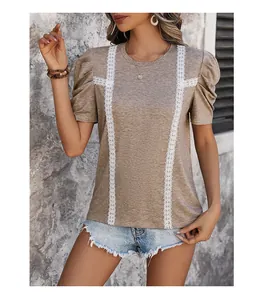 Close-up of khaki T-shirt with puff sleeves and white lace floral embroidery detail