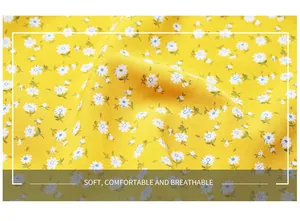 Detail of yellow floral daisy print on soft, breathable summer dress fabric