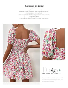 Detail of floral mini dress showing smocked waist and puffed sleeves on white background