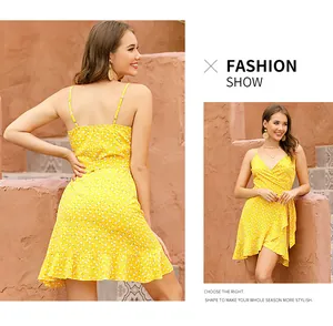 Detail of yellow floral summer mini dress with spaghetti straps and ruffled hem design