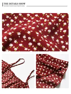 Close-up of dark red floral fabric with white daisy patterns and delicate straps