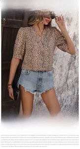 Detail of ruffle V-neckline on summer leopard print blouse with lightweight fabric texture