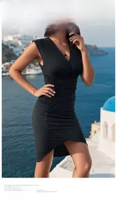 Detail of the V-neckline and elegant ruched texture on this slim sleeveless black dress