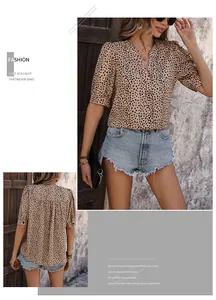 Detail of a casual leopard print V-neck blouse with puff sleeves and back tailoring