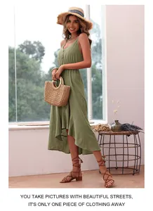 Detail of green cotton linen dress with buttons, high-low ruffle hem and summer accessories