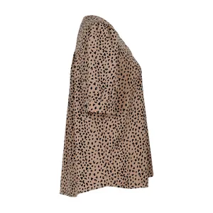 Close-up of leopard print pattern and lightweight fabric texture on casual summer shirt