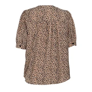 Detail view of the back pleats and buttoned cuffs on a leopard print short sleeve blouse