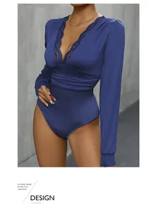Detail of elegant navy bodysuit featuring deep V-neckline with delicate lace patchwork