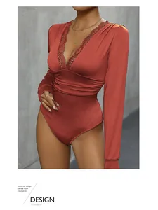 Detail of V-neck lace trim and pleated waist on this burgundy long sleeve bodysuit
