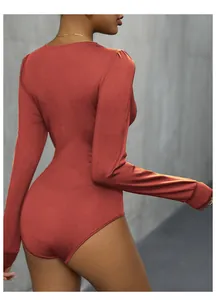 Detail view showing the sleek back fit and textured fabric of the brick red bodysuit