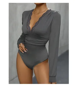 Close-up of elegant V-neckline with delicate lace trim on grey long sleeve bodysuit