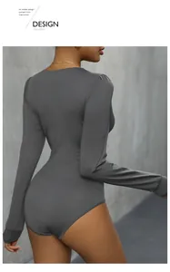 Detail of dark grey long sleeve bodysuit showing slim fit design and crew neck style