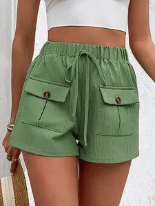 Detail of sage green high-waisted shorts featuring cargo pockets and drawstring waist