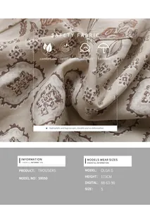 Detail of paisley print wide-leg trousers showing breathable fabric texture and model info