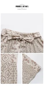 Detail of high waisted wide leg pants featuring bohemian floral print and waist bow tie