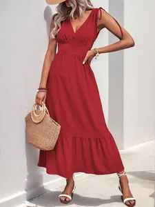 Detail of burgundy V-neck maxi dress featuring tie-up shoulders and ruffled hemline
