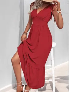 Detail of red backless maxi dress featuring shoulder ties and elegant ruffled hemline