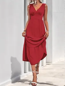 Detail of red tiered maxi dress with bow shoulder straps and textured pleated fabric