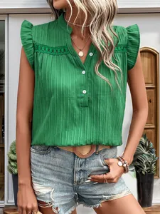Close-up of bright green sleeveless shirt with lace patchwork and ruffle shoulder details