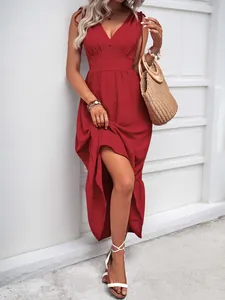 Detail of red deep V-neck maxi dress with shoulder ties and ruffled tiered hemline