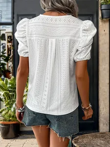 Back view of white lace hollow embroidery blouse with puff sleeves and casual blue shorts