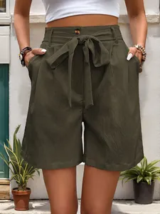 Detail view of high-waisted olive green cotton linen shorts with tie belt and side pockets