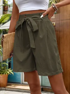 Close-up of olive green high-waisted shorts featuring a self-tie bow and side pockets