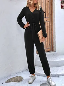 Women's black V-neck long sleeve jumpsuit with waist tie and elasticated cuffs and hem
