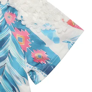 Detailed view of sky blue t-shirt with lace crochet trim and colorful feather prints