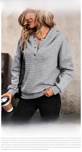 Detail of grey waffle knit hoodie featuring buttoned Henley neckline and relaxed fit texture