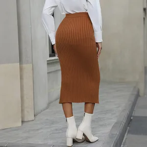 Back view of a caramel ribbed knit midi skirt with a high waist and slim fit
